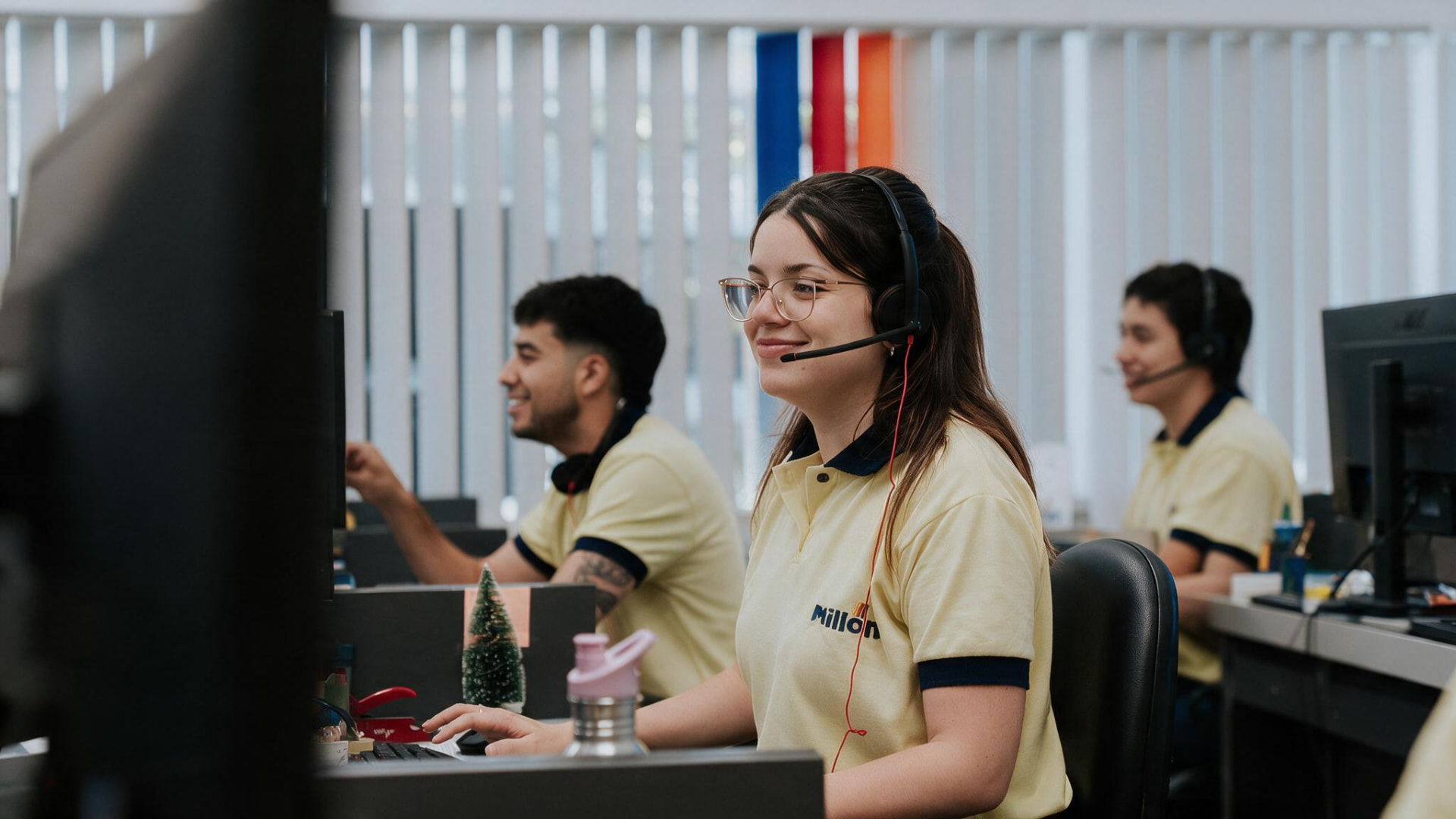 Equipo de atención al cliente de Millón trabajando con auriculares